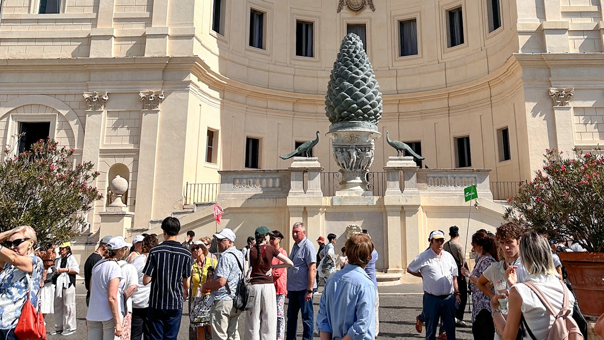 Visitors gather near the Pinecone Courtyard on a Vatican Museums guided tour.