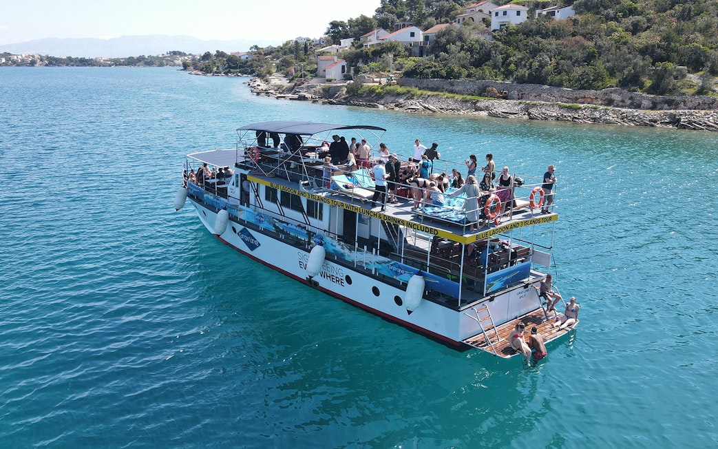 Tourists enjoying a boat cruise near the coast of Šolta, Croatia.
