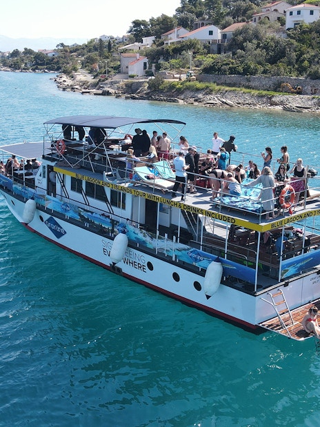 Tourists enjoying a boat cruise near the coast of Šolta, Croatia.