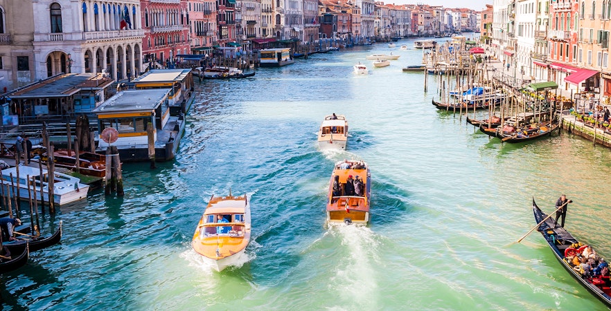 Boats and gondolas navigating the Grand Canal in Venice, Italy.