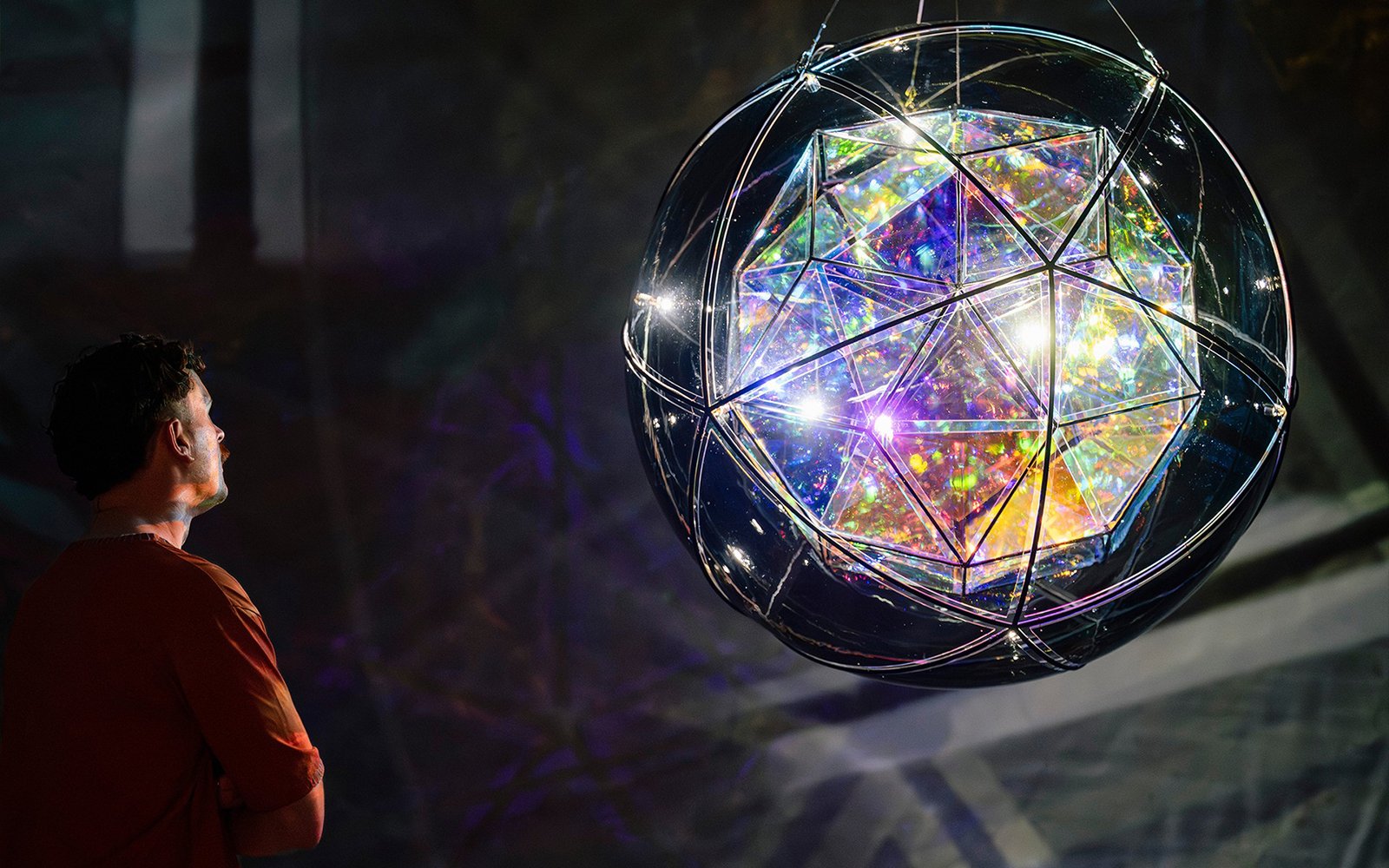 Man observing Olafur Eliasson's geometric light sculpture at Gallery of Modern Art.
