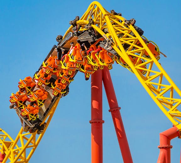 Roller coaster loop at Six Flags: Great America with riders in orange seats.