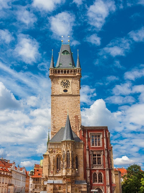 Old Town Hall medieval clock tower in Prague under a blue sky.