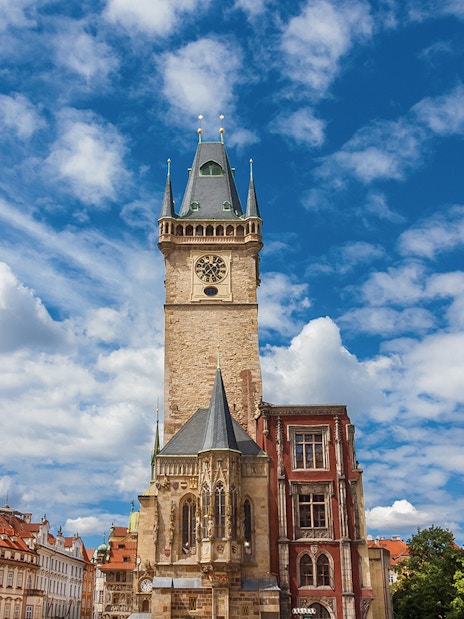 Old Town Hall medieval clock tower in Prague under a blue sky.