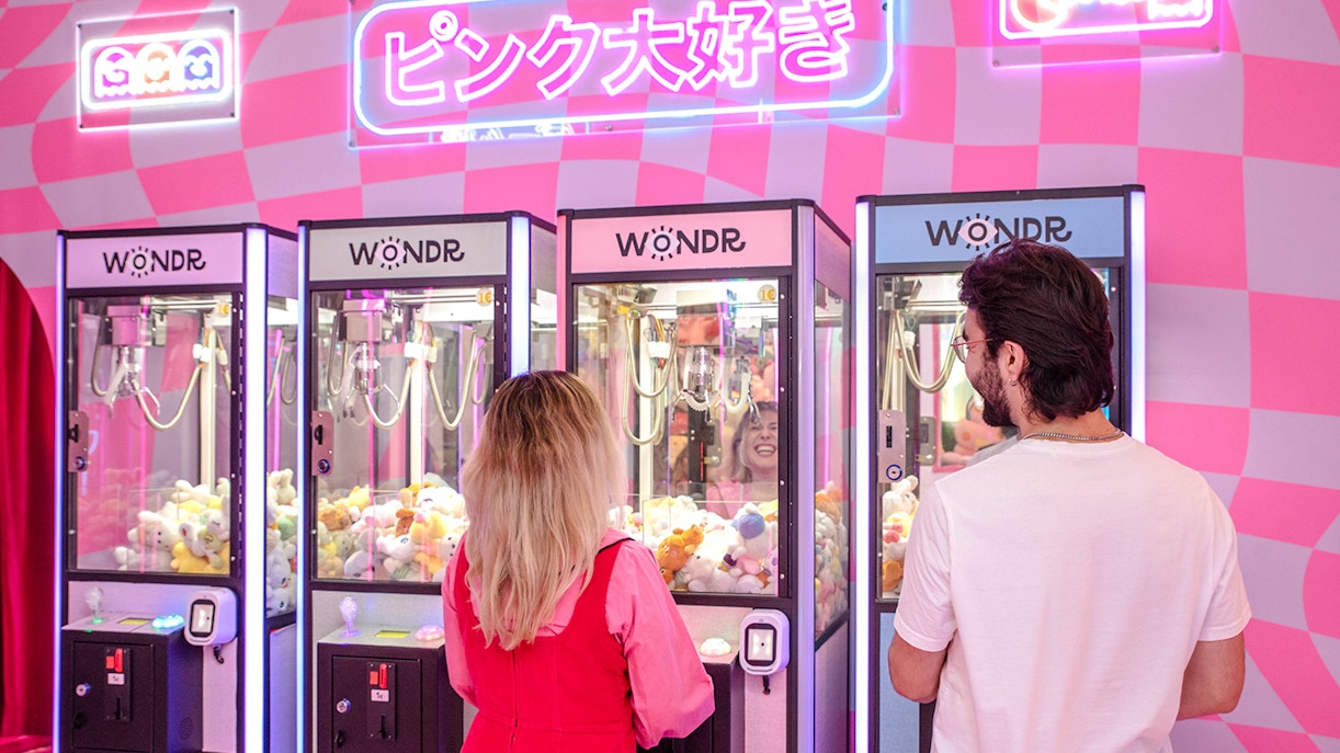 Guests playing claw machines at WONDR Experience in Amsterdam.