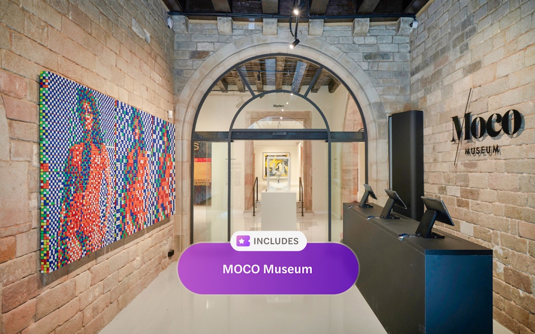 Entrance of MOCO Museum in Barcelona with colorful artwork and reception desk.