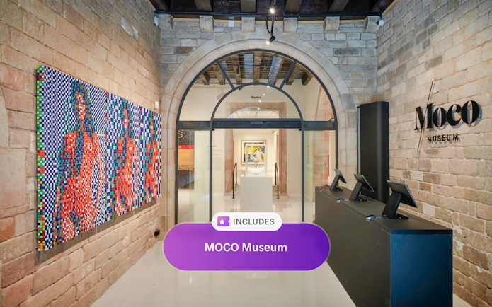 Entrance of MOCO Museum in Barcelona with colorful artwork and reception desk.