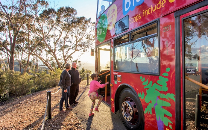 Family boarding Hop-On Hop-Off bus in Blue Mountains, Australia.