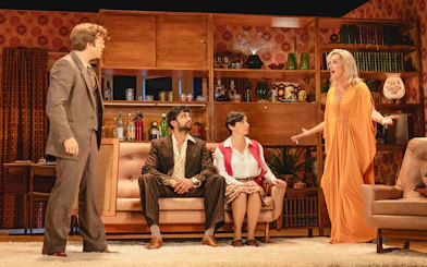 Stage scene from Abigail's Party in Westend with actors in a 1970s living room setting.