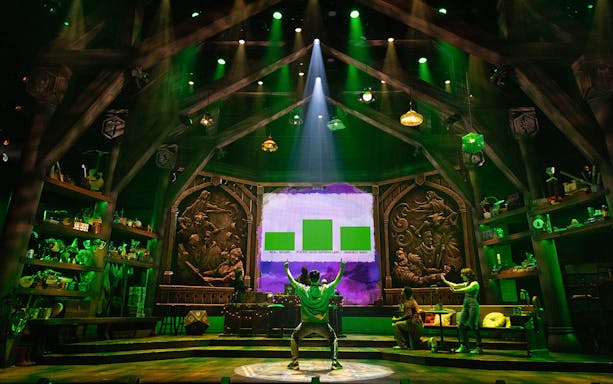 Stage set of Dungeons & Dragons: The Twenty-Sided Tavern with actors and fantasy decor.