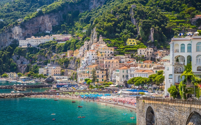 Scenic view of Amalfi town with colorful buildings and beach on the Amalfi Coast.