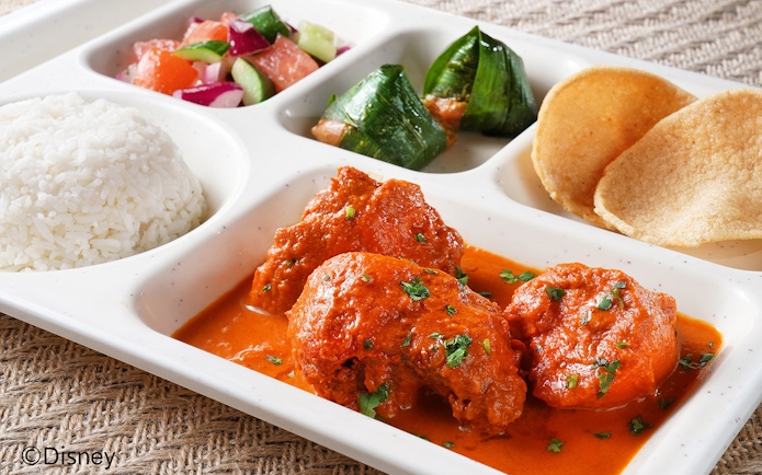 Traditional meal with curry, rice, salad, and snacks at Disneyland Hong Kong.