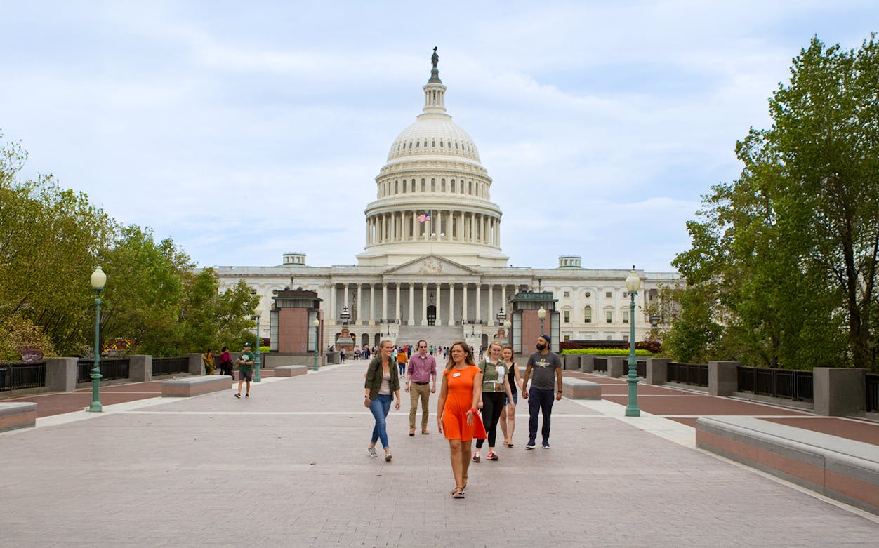Tour guide leading tourists near the Capitol Building in Washington D.C.