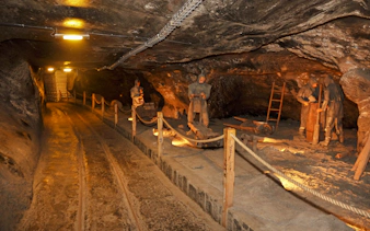 Salt Mine Wieliczka tunnel with miner statues, Krakow tour.