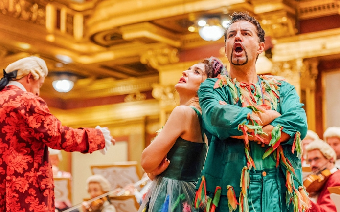 Performers in colorful costumes at Mozart Orchestra Concert, Golden Hall, Vienna.
