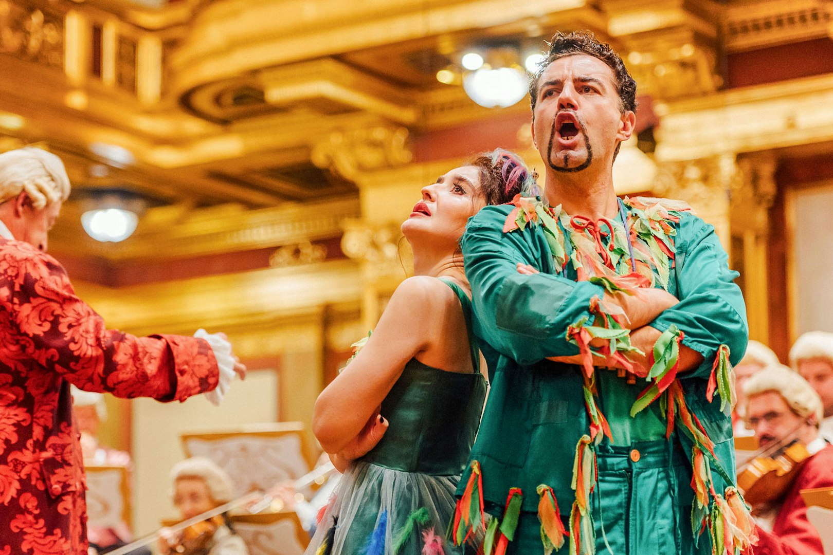 Performers in colorful costumes at Mozart Orchestra Concert, Golden Hall, Vienna.