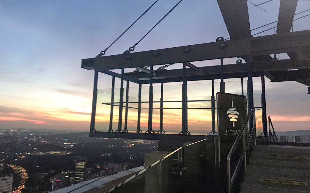 KL Tower SkyBox overlooking Kuala Lumpur cityscape at sunset.