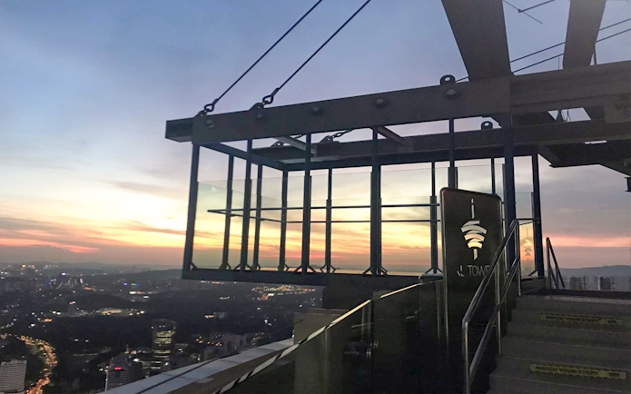 KL Tower SkyBox overlooking Kuala Lumpur cityscape at sunset.