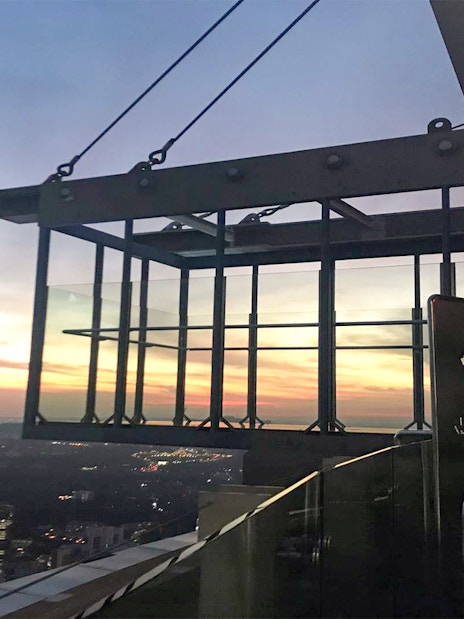 KL Tower SkyBox overlooking Kuala Lumpur cityscape at sunset.