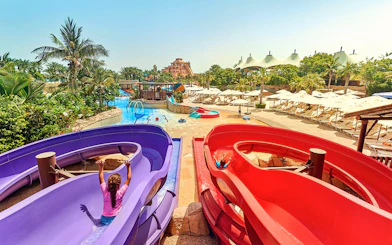 Children enjoying water slides at Aquaventure Waterpark, Dubai.