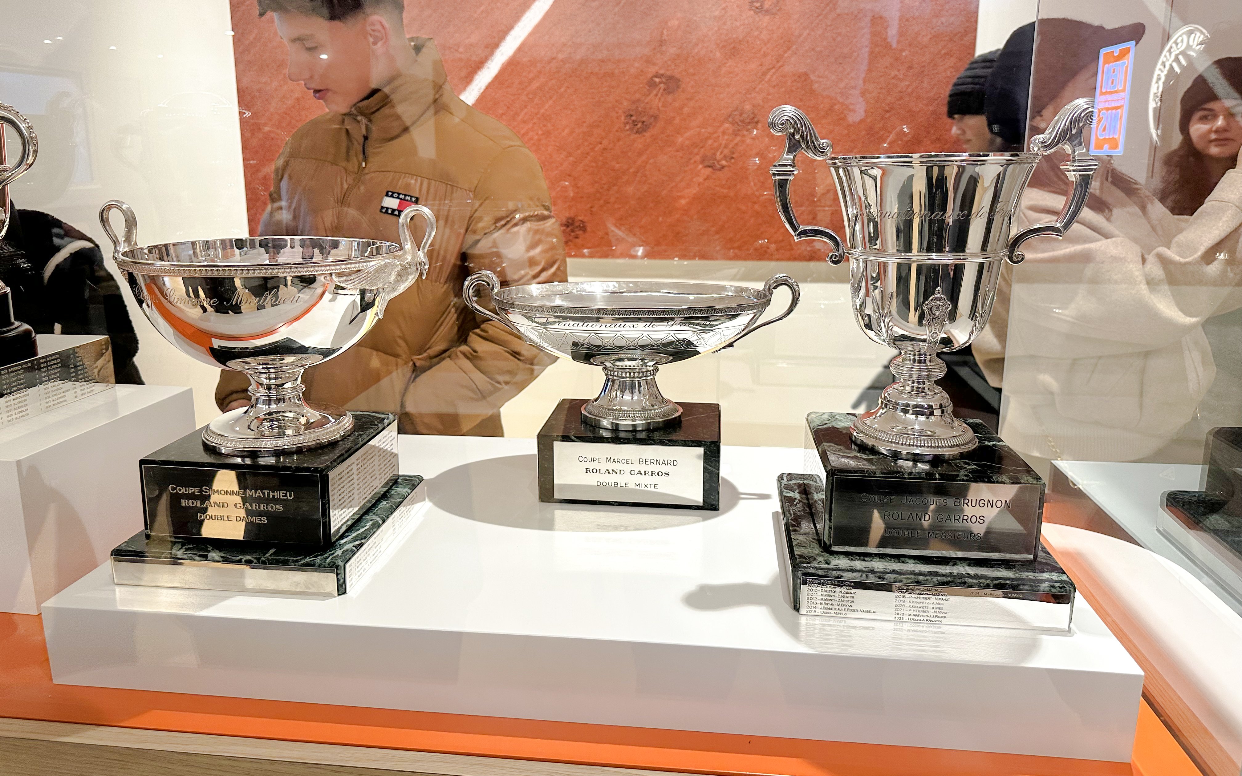 Trophies displayed at Roland-Garros Stadium, including Coupe Simone Mathieu and Coupe Marcel Bernard.