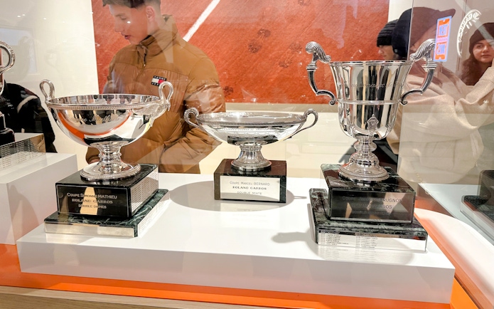 Trophies displayed at Roland-Garros Stadium, including Coupe Simone Mathieu and Coupe Marcel Bernard.