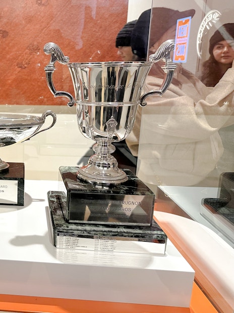 Trophies displayed at Roland-Garros Stadium, including Coupe Simone Mathieu and Coupe Marcel Bernard.