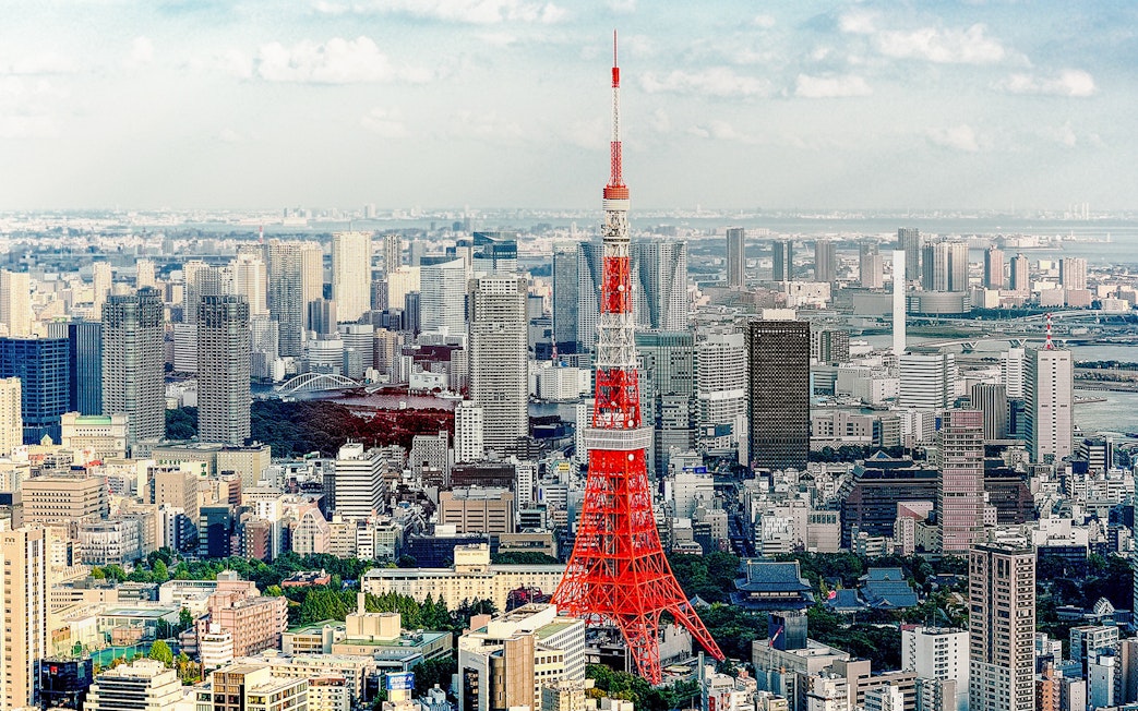 Tokyo Tower with cityscape on a sunny day.