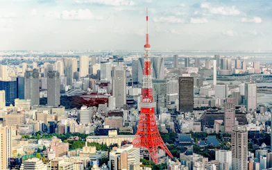 Tokyo Tower with cityscape on a sunny day.