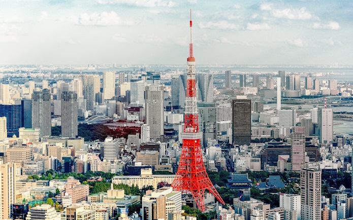 Tokyo Tower with cityscape on a sunny day.
