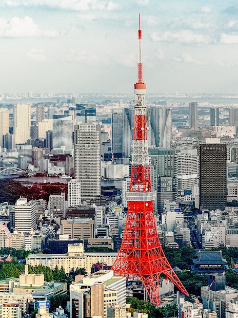 Tokyo Tower with cityscape on a sunny day.