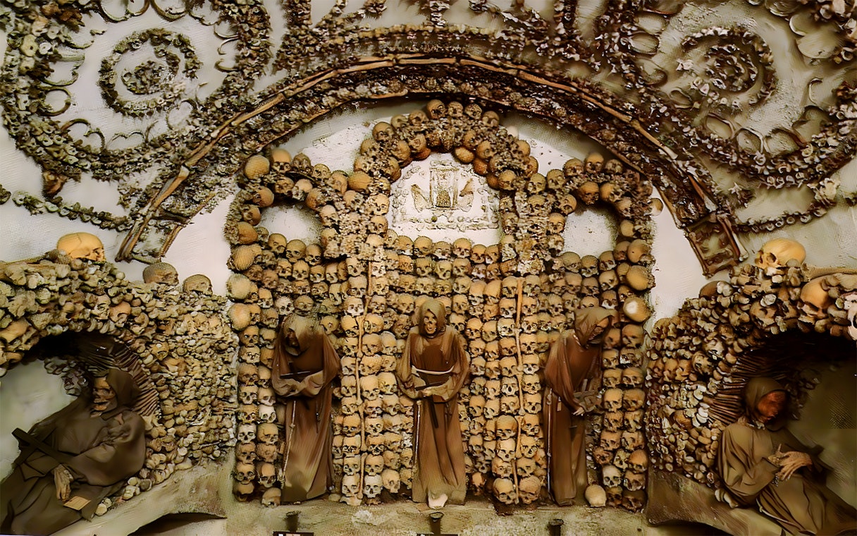 Capuchin Crypt in Rome Catacombs with monk statues and skull decorations.