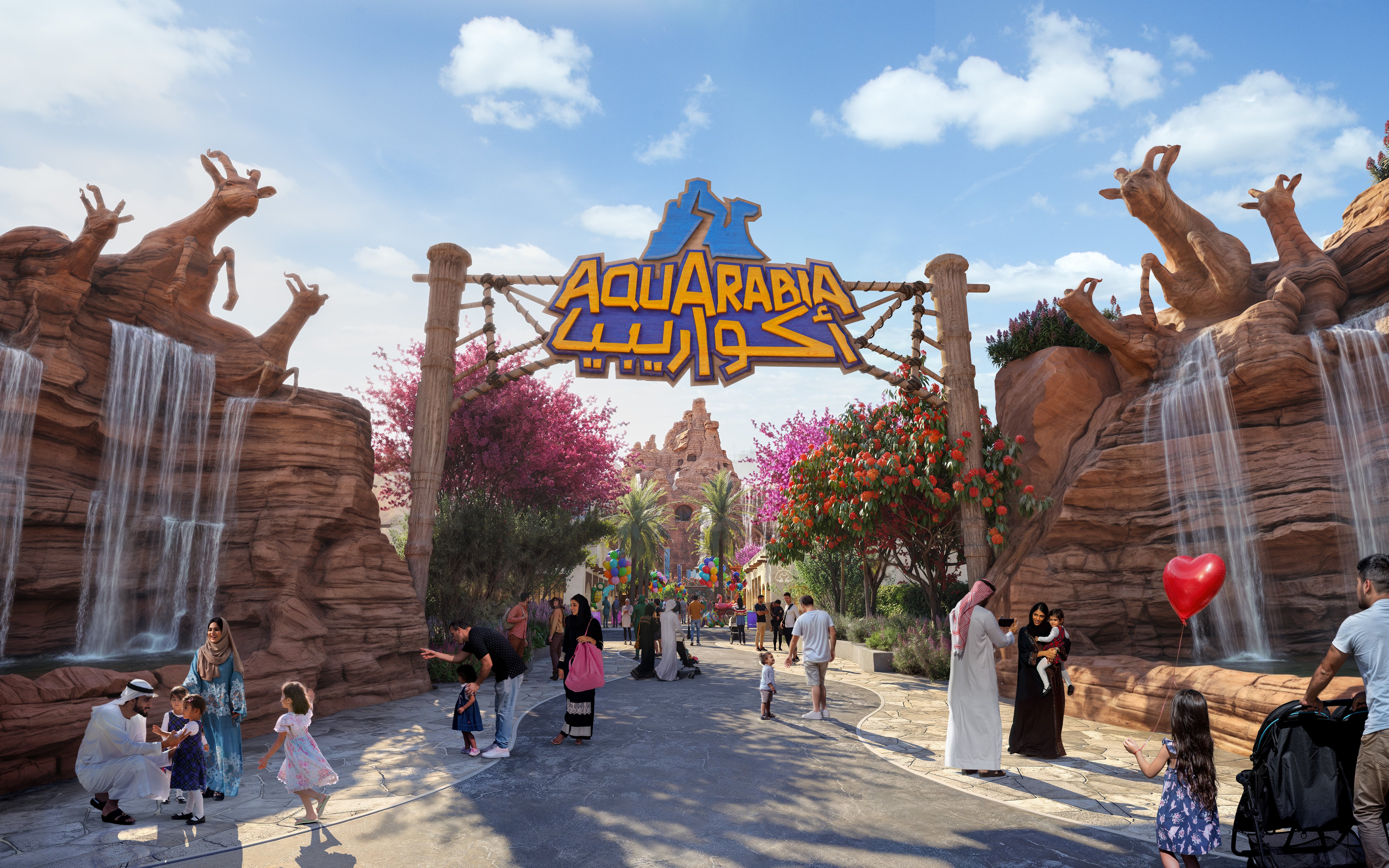 Entrance to Aquarabia with waterfalls and visitors walking under the sign.