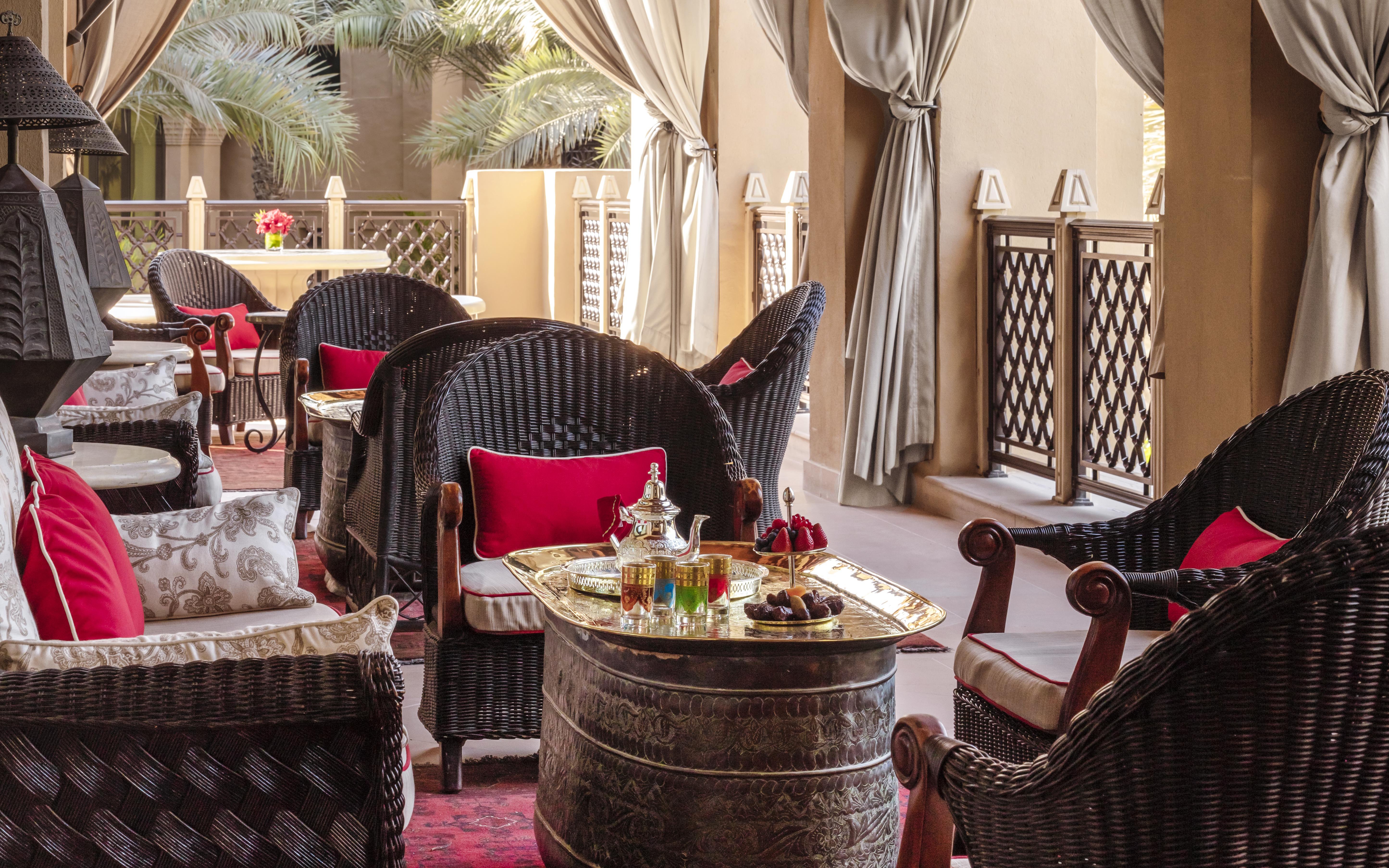 Afternoon tea setup with ornate teapot and cups at The Samovar Lounge, Dubai.