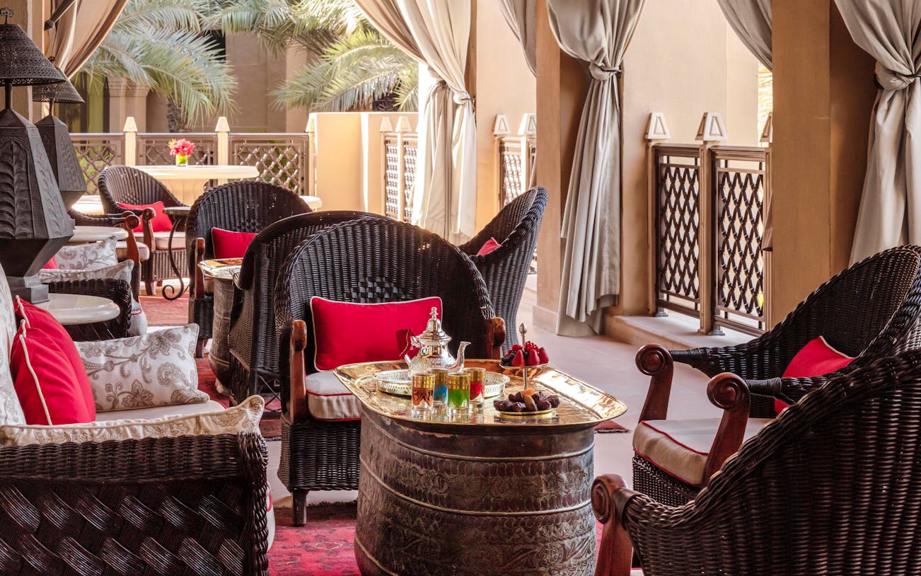 Afternoon tea setup with ornate teapot and cups at The Samovar Lounge, Dubai.
