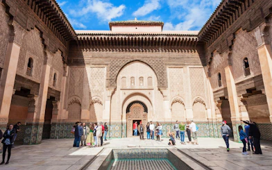 Ben Youssef Medersa courtyard with visitors, Marrakech.