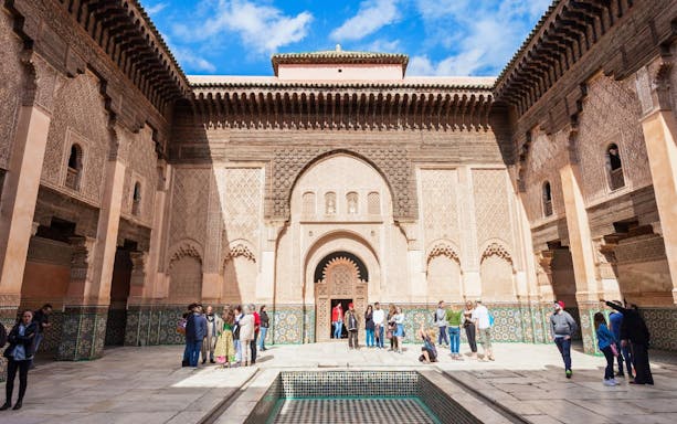 Ben Youssef Medersa courtyard with visitors, Marrakech.