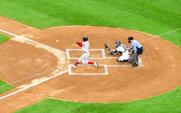 Baseball game between New York Yankees and Kansas City Royals, batter swinging at pitch.