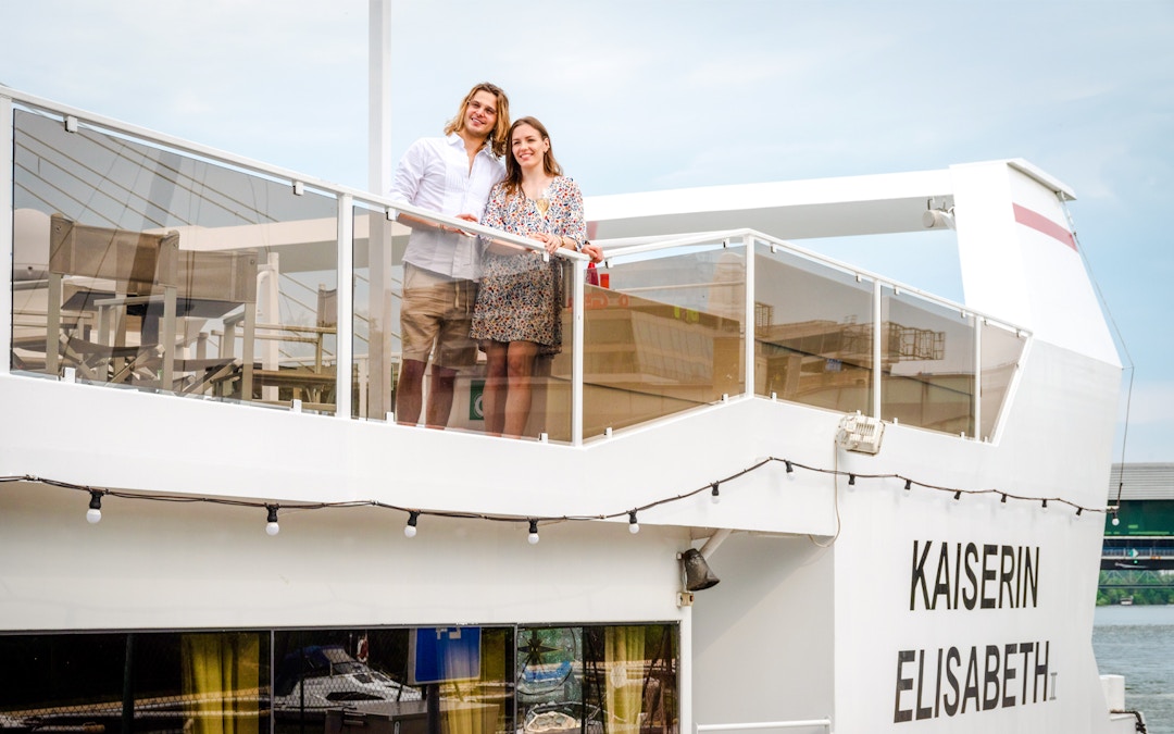 Man and woman on the deck of Kaiserin Elisabeth river cruise ship in Vienna.
