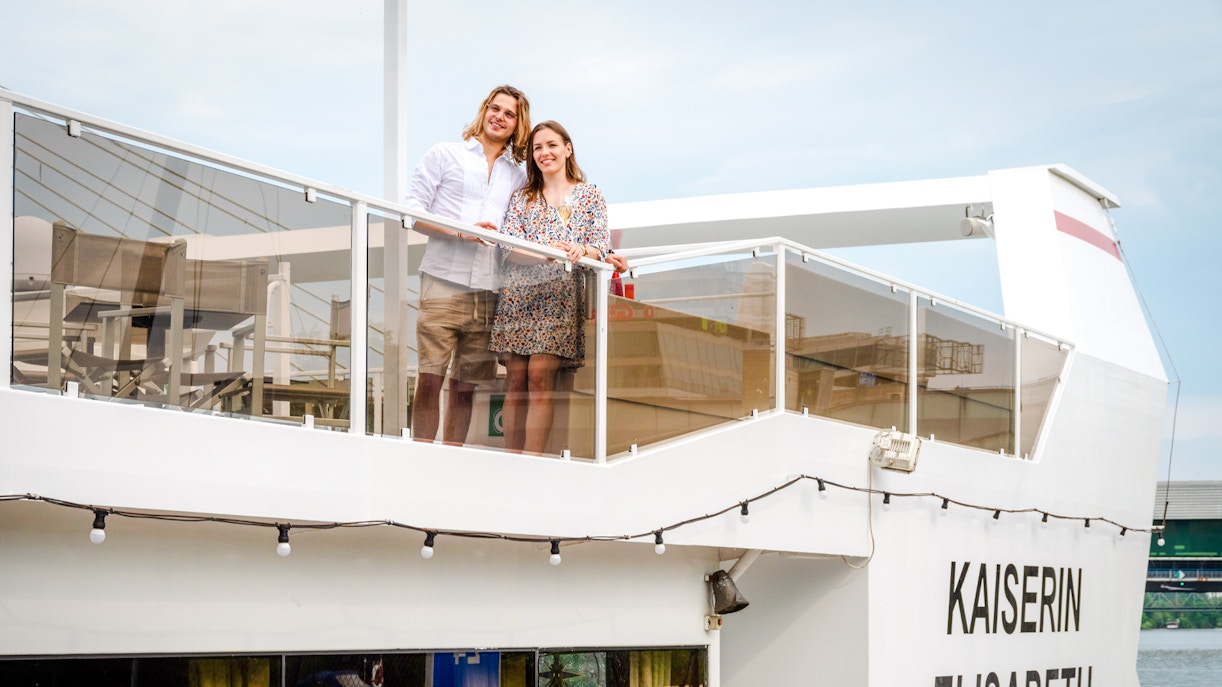 Man and woman on the deck of Kaiserin Elisabeth river cruise ship in Vienna.