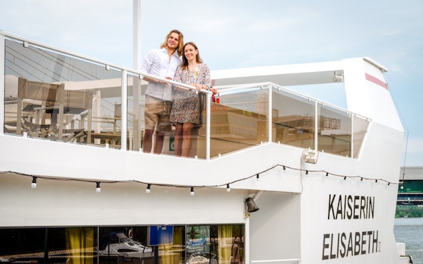 Man and woman on the deck of Kaiserin Elisabeth river cruise ship in Vienna.