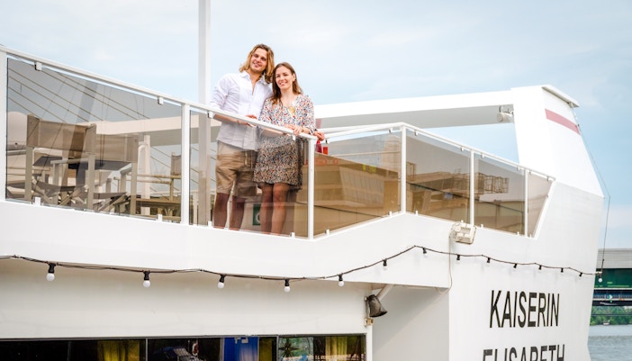 Man and woman on Kaiserin Elisabeth deck during Vienna Danube cruise.