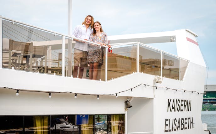 Man and woman on the deck of Kaiserin Elisabeth river cruise ship in Vienna.