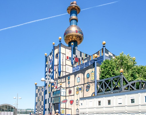 Spittelau incinerator designed by Hundertwasser in Vienna, Austria, featuring colorful facade and unique architecture.