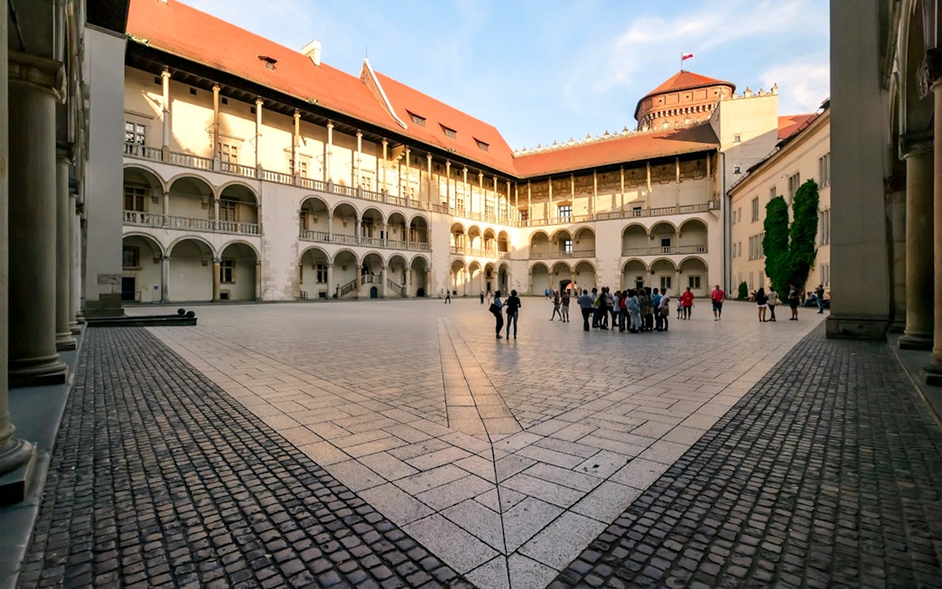Wawel Castle courtyard with a group of tourists, Krakow, Poland.