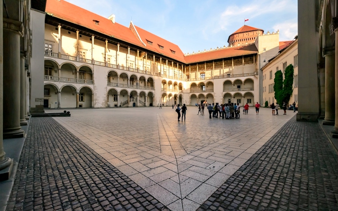 Wawel Castle courtyard with a group of tourists, Krakow, Poland.