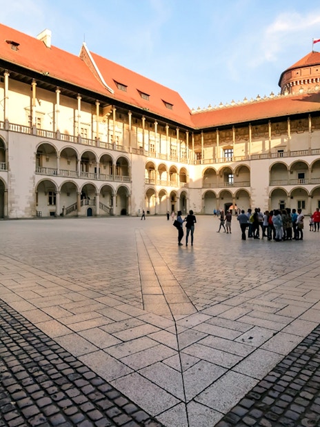 Wawel Castle courtyard with a group of tourists, Krakow, Poland.