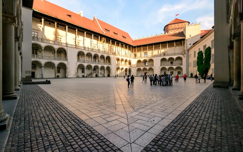 Wawel Castle courtyard with a group of tourists, Krakow, Poland.