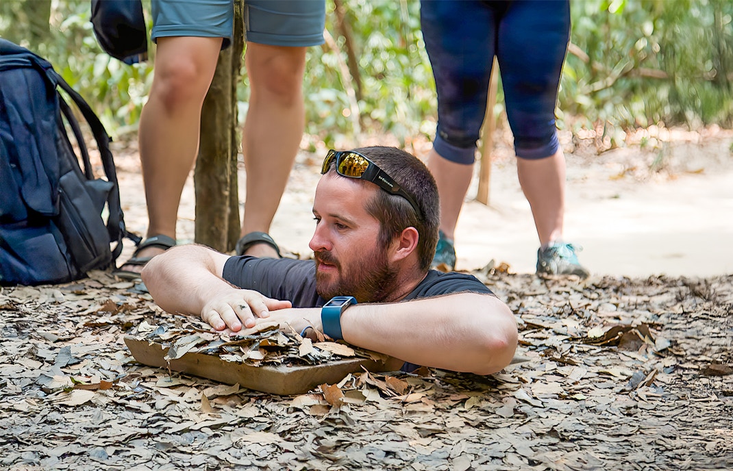Man emerging from Cu Chi Tunnel in Vietnam.