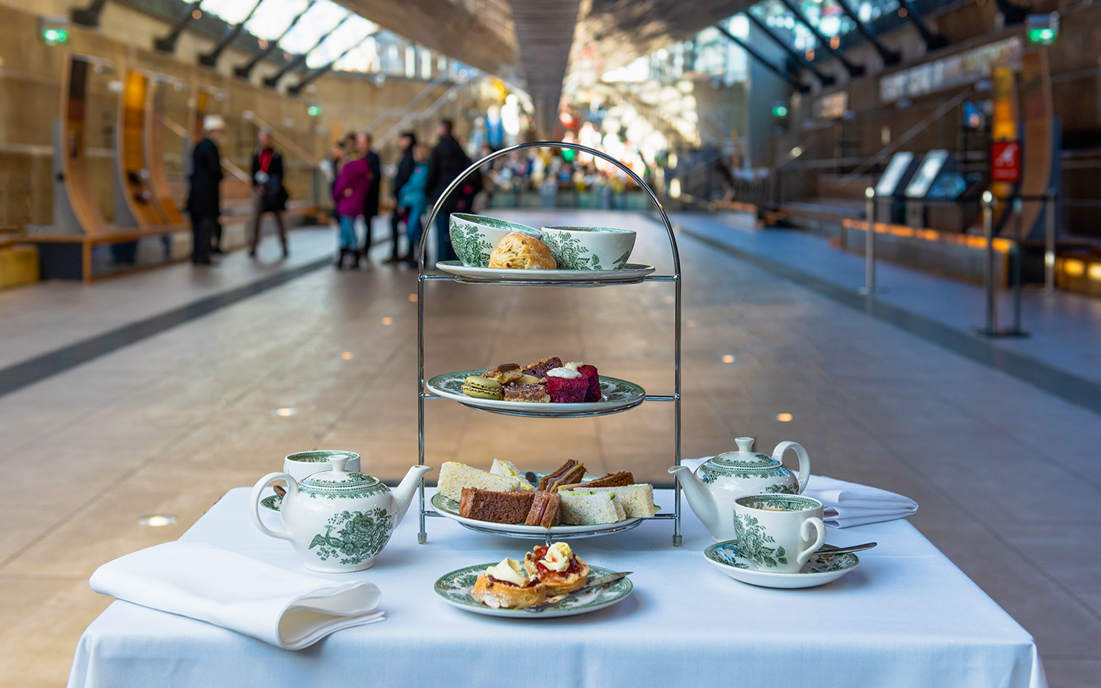 Afternoon tea setup with pastries and sandwiches at Cutty Sark, London.